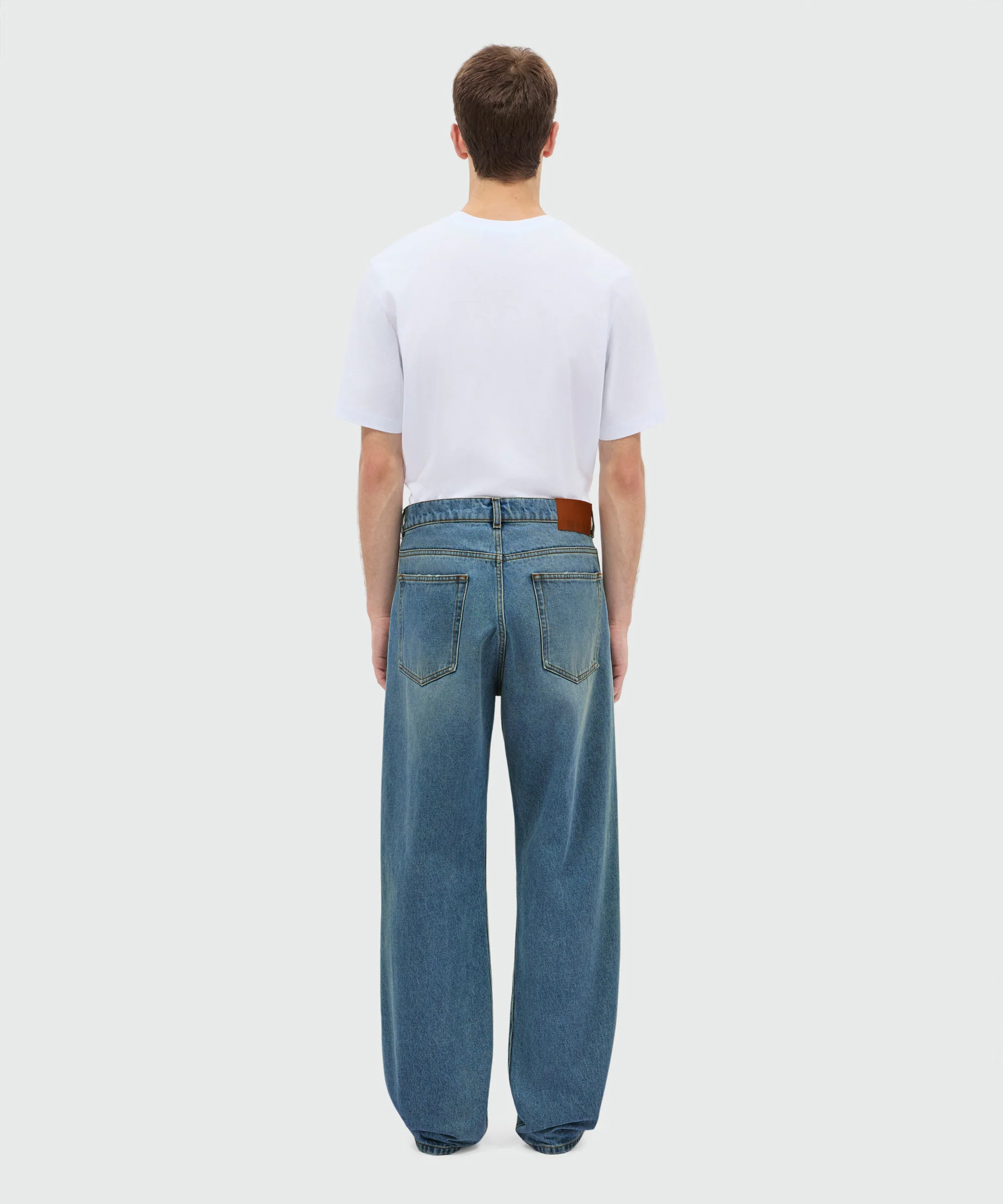 Medium-wash denim trousers with localized distressing, five-pocket design - Image 3